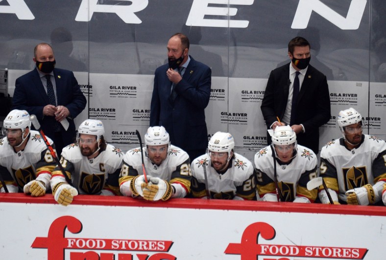 Jan 22, 2021; Glendale, Arizona, USA; Vegas Golden Knights head coach Peter DeBoer (center) looks on against the Arizona Coyotes during the first period at Gila River Arena. Mandatory Credit: Joe Camporeale-USA TODAY Sports