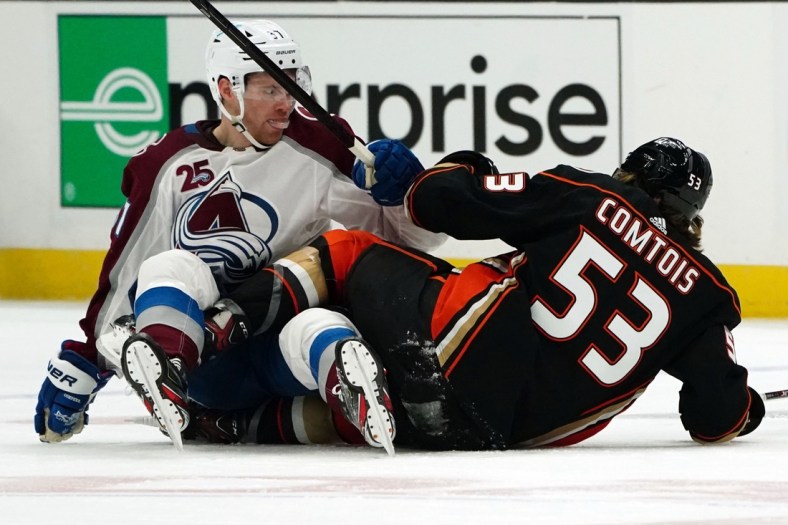 Jan 22, 2021; Anaheim, California, USA; Anaheim Ducks left wing Max Comtois (53) and center Troy Terry (61) collide with Colorado Avalanche left wing J.T. Compher (37) in the second period at Honda Center. Mandatory Credit: Kirby Lee-USA TODAY Sports