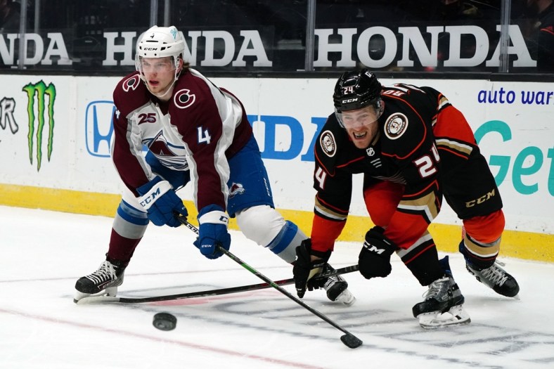 Jan 22, 2021; Anaheim, California, USA; Colorado Avalanche  defenseman Bowen Byram (4)  and Anaheim Ducks right wing Carter Rowney (24) battle for the puck in the third period at Honda Center. The Avalanche defeated the Ducks 3-2 in overtime. Mandatory Credit: Kirby Lee-USA TODAY Sports