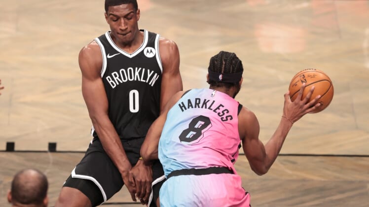 Jan 23, 2021; Brooklyn, New York, USA; Miami Heat forward Maurice Harkless (8) passes the ball against Brooklyn Nets forward Reggie Perry (0) during the first half at Barclays Center. Mandatory Credit: Vincent Carchietta-USA TODAY Sports