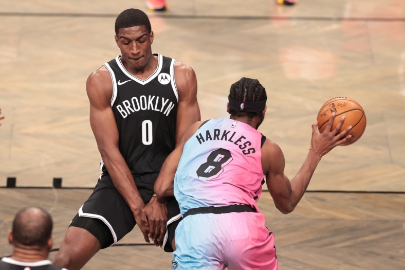 Jan 23, 2021; Brooklyn, New York, USA; Miami Heat forward Maurice Harkless (8) passes the ball against Brooklyn Nets forward Reggie Perry (0) during the first half at Barclays Center. Mandatory Credit: Vincent Carchietta-USA TODAY Sports