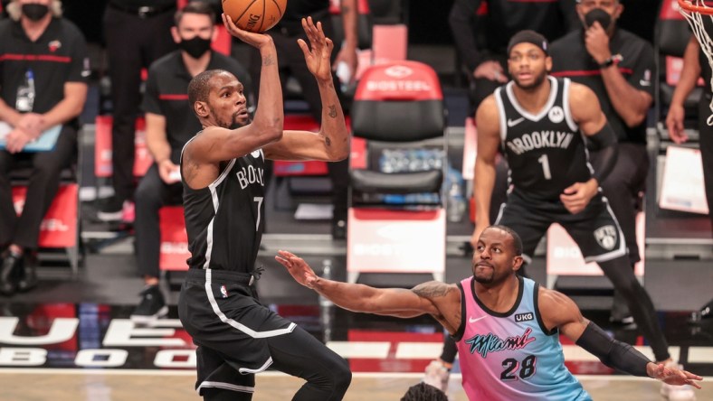 Jan 23, 2021; Brooklyn, New York, USA; Brooklyn Nets forward Kevin Durant (7) shoots the ball against Miami Heat forward Andre Iguodala (28) during the second half at Barclays Center. Mandatory Credit: Vincent Carchietta-USA TODAY Sports