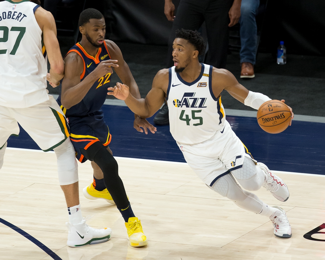 Jan 23, 2021; Salt Lake City, Utah, USA; Utah Jazz guard Donovan Mitchell (45) dribbles the ball around a screen by center Rudy Gobert (27) against Golden State Warriors forward Andrew Wiggins (22) during the second half at Vivint Smart Home Arena. Mandatory Credit: Russell Isabella-USA TODAY Sports