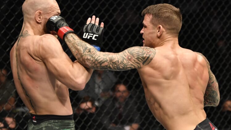 Jan 23, 2021; Abu Dhabi, United Arab Emirates; Dustin Poirier punches Conor McGregor of Ireland in a lightweight fight during the UFC 257 event inside Etihad Arena on UFC Fight Island.  Mandatory Credit: Jeff Bottari/Handout Photo via USA TODAY Sports