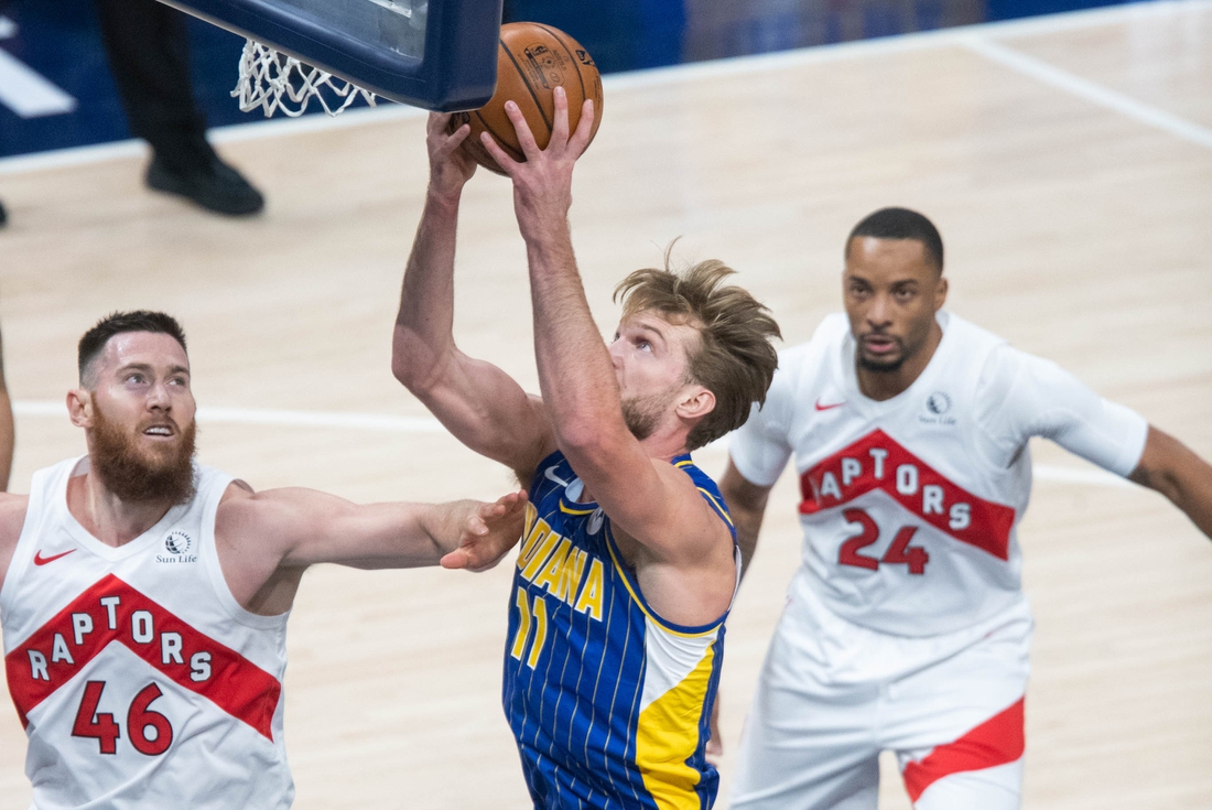 Jan 24, 2021; Indianapolis, Indiana, USA; Indiana Pacers forward Domantas Sabonis (11) shoots the ball while Toronto Raptors center Aron Baynes (46) defends in the first quarter at Bankers Life Fieldhouse. Mandatory Credit: Trevor Ruszkowski-USA TODAY Sports