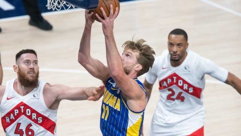 Jan 24, 2021; Indianapolis, Indiana, USA; Indiana Pacers forward Domantas Sabonis (11) shoots the ball while Toronto Raptors center Aron Baynes (46) defends in the first quarter at Bankers Life Fieldhouse. Mandatory Credit: Trevor Ruszkowski-USA TODAY Sports