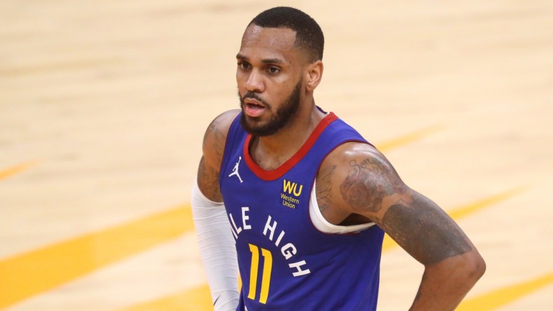 Jan 22, 2021; Phoenix, Arizona, USA; Denver Nuggets guard Monte Morris (11) against the Phoenix Suns at Phoenix Suns Arena. Mandatory Credit: Mark J. Rebilas-USA TODAY Sports