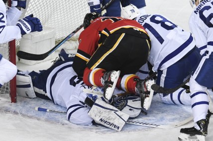 Jan 24, 2021; Calgary, Alberta, CAN; Calgary Flames forward Matthew Tkachuk (19) ends up on top of Toronto Maple Leafs goalie Jack Campbell (36) during the third period at Scotiabank Saddledome. Mandatory Credit: Candice Ward-USA TODAY Sports