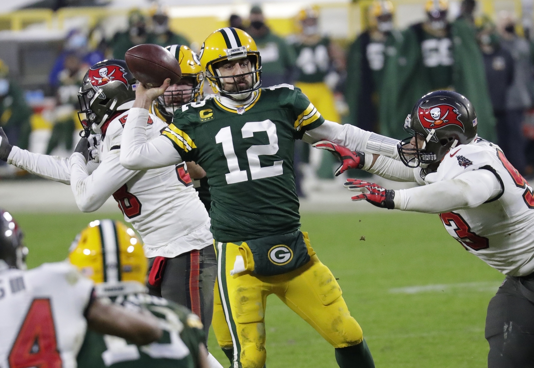 Jan 24, 2021, Green Bay, WI, USA; Green Bay Packers quarterback Aaron Rodgers (12) throws an inccomplete pass against Tampa Bay Buccaneers defensive end Ndamukong Suh (93) in the final minutes of the game during the NFC championship game Sunday, January 24, 2021, at Lambeau Field Mandatory credit: Dan Powers / Milwaukee Journal Sentinel via USA TODAY NETWORK