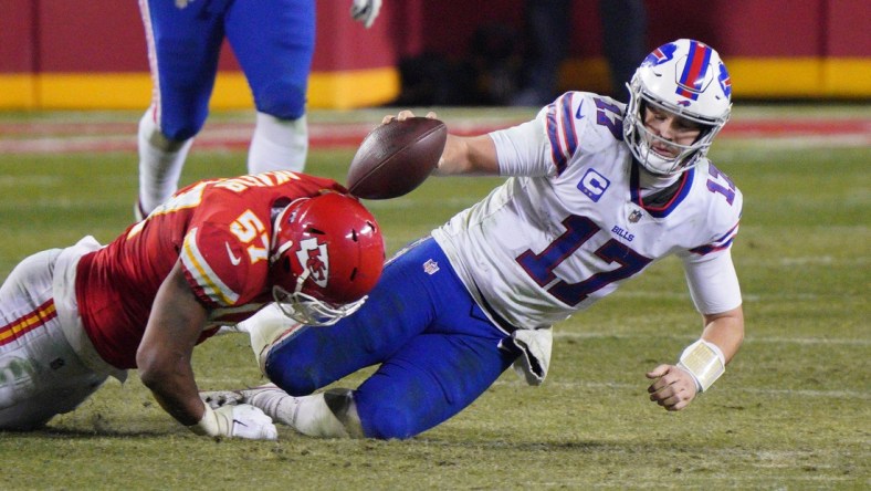 Jan 24, 2021; Kansas City, MO, USA; Buffalo Bills quarterback Josh Allen (17) is tackled by Kansas City Chiefs defensive end Alex Okafor (57) during the fourth quarter in the AFC Championship Game at Arrowhead Stadium. Mandatory Credit: Denny Medley-USA TODAY Sports