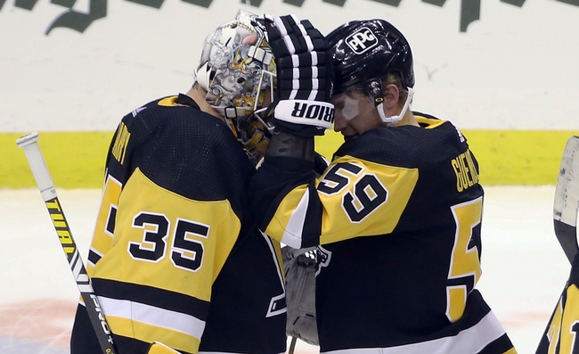 Jan 24, 2021; Pittsburgh, Pennsylvania, USA;  Pittsburgh Penguins goaltender Tristan Jarry (35) and left wing Jake Guentzel (59) celebrate after defeating the New York Rangers at the PPG Paints Arena. The Penguins won 3-2. Mandatory Credit: Charles LeClaire-USA TODAY Sports