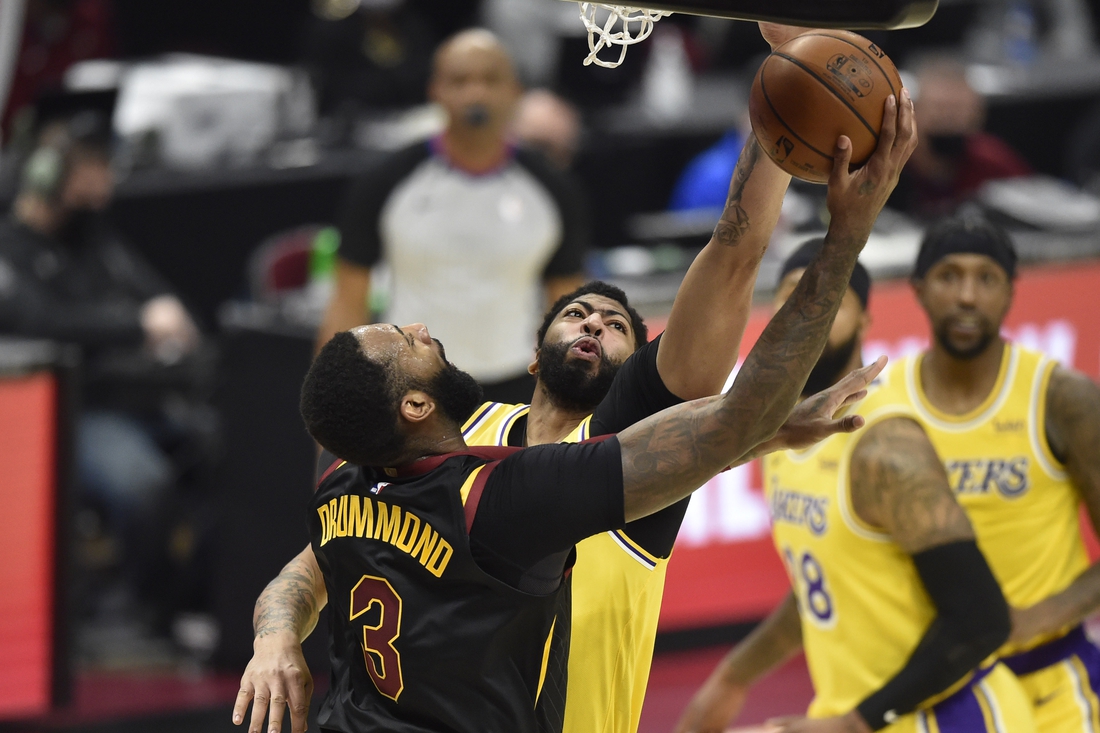 Jan 25, 2021; Cleveland, Ohio, USA; Los Angeles Lakers forward Anthony Davis (3) defends a shot by Cleveland Cavaliers center Andre Drummond (3) in the second quarter at Rocket Mortgage FieldHouse. Mandatory Credit: David Richard-USA TODAY Sports