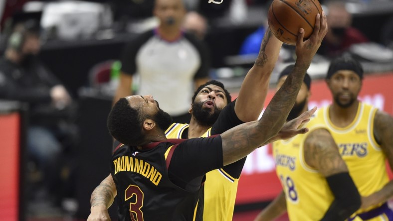 Jan 25, 2021; Cleveland, Ohio, USA; Los Angeles Lakers forward Anthony Davis (3) defends a shot by Cleveland Cavaliers center Andre Drummond (3) in the second quarter at Rocket Mortgage FieldHouse. Mandatory Credit: David Richard-USA TODAY Sports