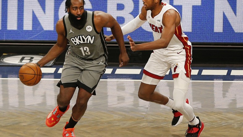 Jan 25, 2021; Brooklyn, New York, USA; Brooklyn Nets guard James Harden (13) dribbles the ball while being defended by Miami Heat forward KZ Okpala (4) during the second half at Barclays Center. Mandatory Credit: Andy Marlin-USA TODAY Sports