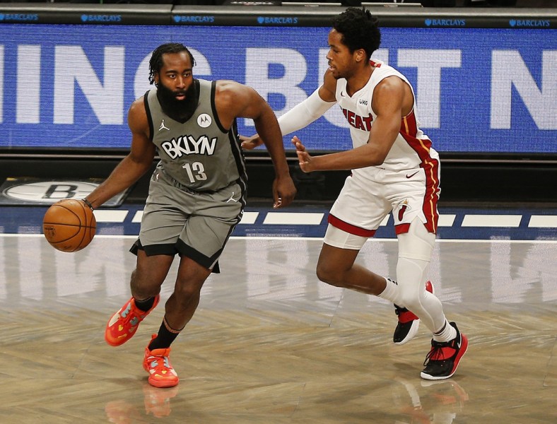Jan 25, 2021; Brooklyn, New York, USA; Brooklyn Nets guard James Harden (13) dribbles the ball while being defended by Miami Heat forward KZ Okpala (4) during the second half at Barclays Center. Mandatory Credit: Andy Marlin-USA TODAY Sports