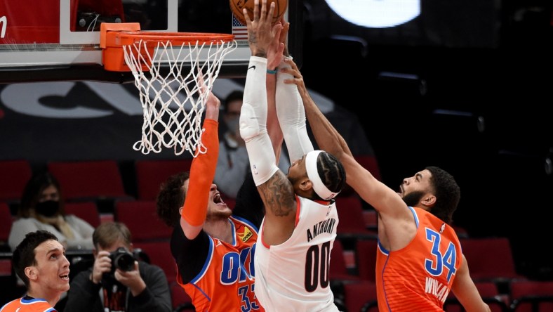 Jan 25, 2021; Portland, Oregon, USA; Portland Trail Blazers forward Carmelo Anthony (00) goes up for a shot on Oklahoma City Thunder center Mike Muscala (33) and guard Kenrich Williams (34) during the first half at Moda Center. Mandatory Credit: Steve Dykes-USA TODAY Sports