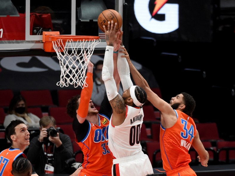Jan 25, 2021; Portland, Oregon, USA; Portland Trail Blazers forward Carmelo Anthony (00) goes up for a shot on Oklahoma City Thunder center Mike Muscala (33) and guard Kenrich Williams (34) during the first half at Moda Center. Mandatory Credit: Steve Dykes-USA TODAY Sports