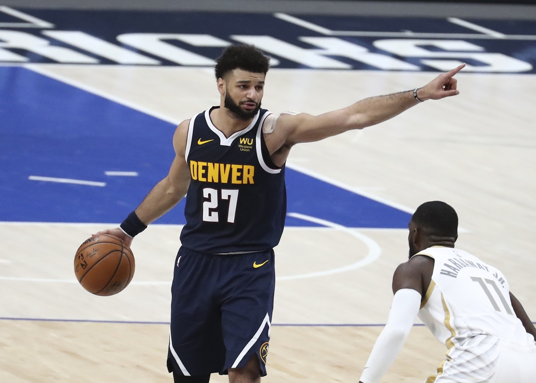 Jan 25, 2021; Dallas, Texas, USA; Denver Nuggets guard Jamal Murray (27) calls out a play as Dallas Mavericks forward Tim Hardaway Jr. (11) defends during the second half at American Airlines Center. Mandatory Credit: Kevin Jairaj-USA TODAY Sports