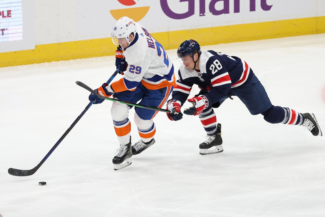 Jan 26, 2021; Washington, District of Columbia, USA; New York Islanders center Brock Nelson (29) skates with the puck as Washington Capitals left wing Daniel Carr (28 0 defends in the second period at Capital One Arena. Mandatory Credit: Geoff Burke-USA TODAY Sports