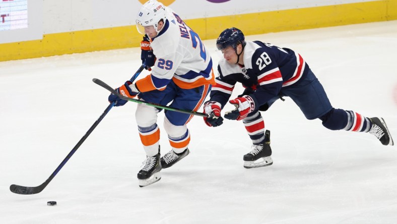 Jan 26, 2021; Washington, District of Columbia, USA; New York Islanders center Brock Nelson (29) skates with the puck as Washington Capitals left wing Daniel Carr (28 0 defends in the second period at Capital One Arena. Mandatory Credit: Geoff Burke-USA TODAY Sports