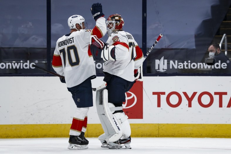 Jan 26, 2021; Columbus, Ohio, USA; Florida Panthers right wing Patric Hornqvist (70) celebrates with goaltender Sergei Bobrovsky (72) after defeating the Columbus Blue Jackets in a shootout at Nationwide Arena. Mandatory Credit: Aaron Doster-USA TODAY Sports