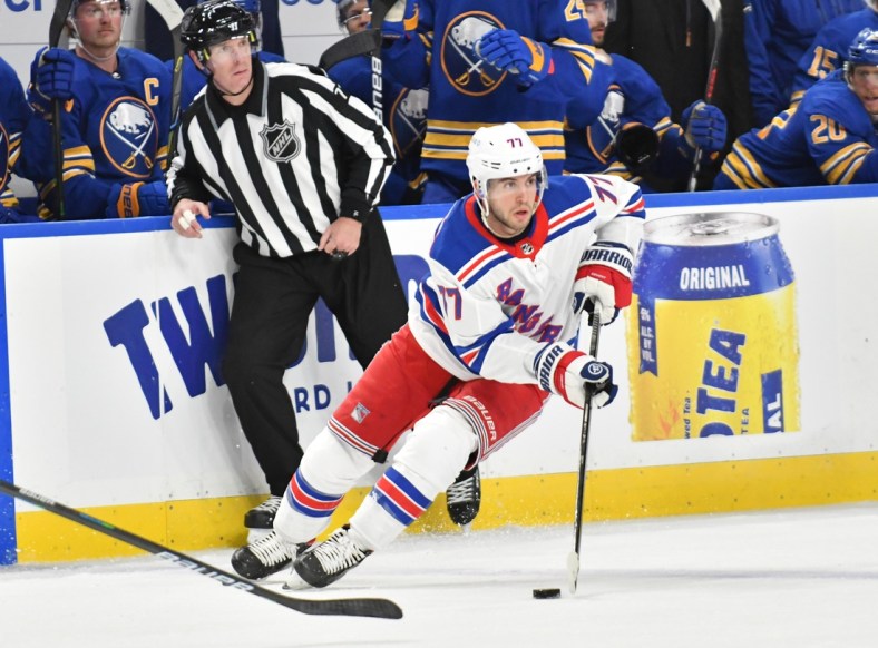 Jan 26, 2021; Buffalo, New York, USA; New York Rangers defenseman Tony DeAngelo (77) handles the puck in the third period against the Buffalo Sabres at KeyBank Center. Mandatory Credit: Mark Konezny-USA TODAY Sports