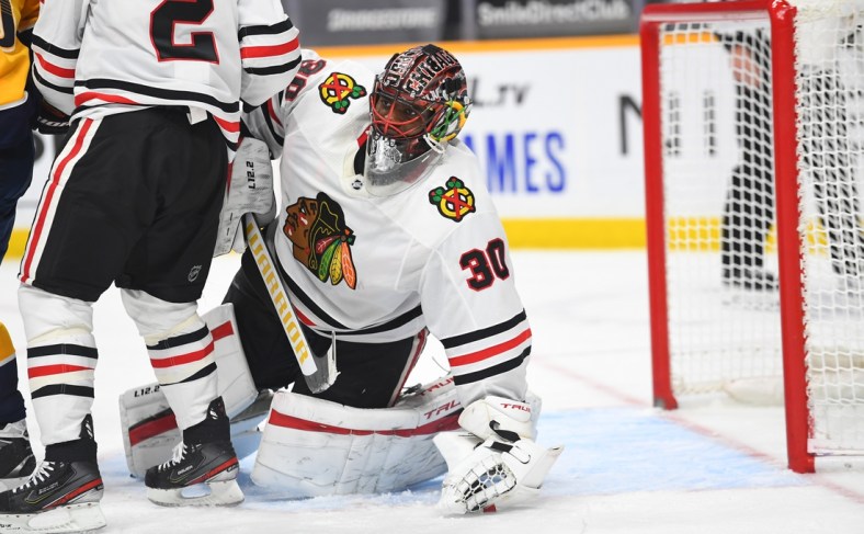 Jan 26, 2021; Nashville, Tennessee, USA; Chicago Blackhawks goaltender Malcolm Subban (30) holds onto the puck after a save during the third period against the Nashville Predators at Bridgestone Arena. Mandatory Credit: Christopher Hanewinckel-USA TODAY Sports