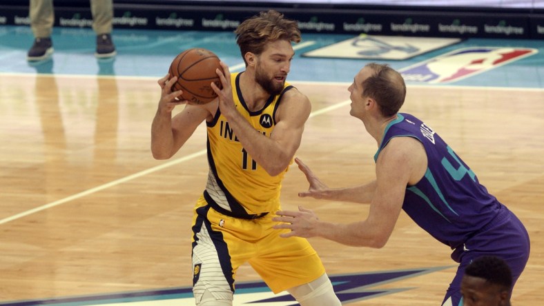 Jan 27, 2021; Charlotte, North Carolina, USA; Indiana Pacers forward Domantas Sabonis (11) looks to pass as he is defended by Charlotte Hornets forward center Cody Zeller (40) during the first half at the Spectrum Center. Mandatory Credit: Sam Sharpe-USA TODAY Sports