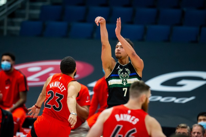 Jan 27, 2021; Tampa, Florida, USA; Milwaukee Bucks guard Bryn Forbes (7) watches his three-point shot go in during the second quarter of a game against the Toronto Raptors at Amalie Arena. Mandatory Credit: Mary Holt-USA TODAY Sports