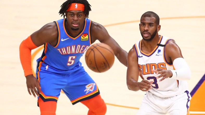 Jan 27, 2021; Phoenix, Arizona, USA; Phoenix Suns guard Chris Paul (3) gets the ball against Oklahoma City Thunder forward Luguentz Dort (5) in the first half at Phoenix Suns Arena. Mandatory Credit: Mark J. Rebilas-USA TODAY Sports