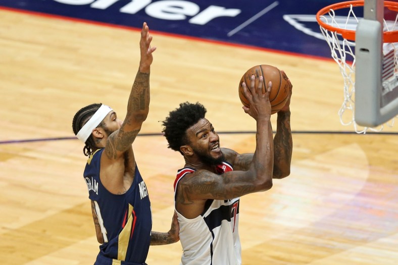 Jan 27, 2021; New Orleans, Louisiana, USA; Washington Wizards center Jordan Bell (7) is defended by New Orleans Pelicans forward Brandon Ingram (14) during the second quarter at the Smoothie King Center. Mandatory Credit: Chuck Cook-USA TODAY Sports