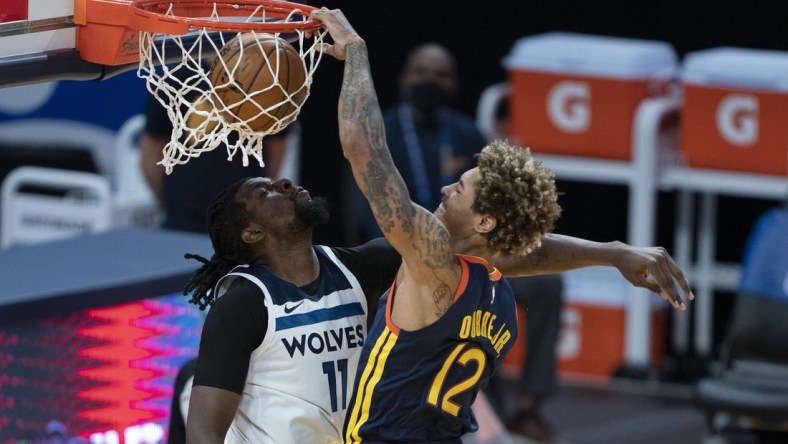 January 27, 2021; San Francisco, California, USA; Golden State Warriors guard Kelly Oubre Jr. (12) dunks the basketball against Minnesota Timberwolves center Naz Reid (11) during the second quarter at Chase Center. Mandatory Credit: Kyle Terada-USA TODAY Sports