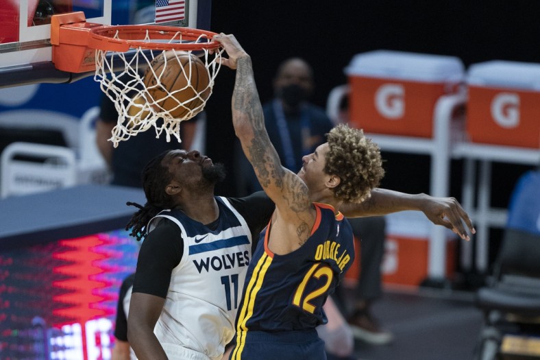 January 27, 2021; San Francisco, California, USA; Golden State Warriors guard Kelly Oubre Jr. (12) dunks the basketball against Minnesota Timberwolves center Naz Reid (11) during the second quarter at Chase Center. Mandatory Credit: Kyle Terada-USA TODAY Sports