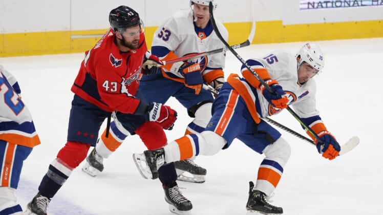 Jan 28, 2021; Washington, District of Columbia, USA; Washington Capitals right wing Tom Wilson (43) trips New York Islanders right wing Cal Clutterbuck (15) while battling for the puck in the first period at Capital One Arena. Mandatory Credit: Geoff Burke-USA TODAY Sports