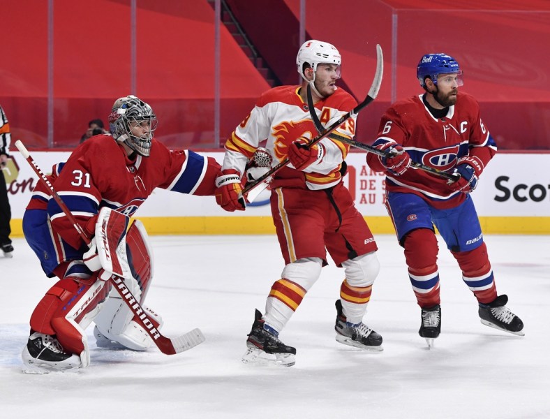 Jan 28, 2021; Montreal, Quebec, CAN; Montreal Canadiens goalie Carey Price (31) and teammate Shea Weber (6) deal with Calgary Flames forward Matthew Tkachuk (19) in front of the net during the first period at the Bell Centre. Mandatory Credit: Eric Bolte-USA TODAY Sports
