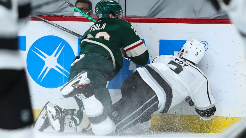 Jan 28, 2021; Saint Paul, Minnesota, USA; Minnesota Wild left wing Kevin Fiala (22) commits a boarding penalty against Los Angeles Kings defenseman Matt Roy (3) in the second period. Fiala was ejected from the game at Xcel Energy Center. Mandatory Credit: David Berding-USA TODAY Sports