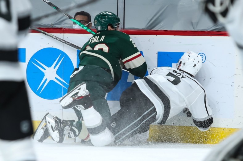 Jan 28, 2021; Saint Paul, Minnesota, USA; Minnesota Wild left wing Kevin Fiala (22) commits a boarding penalty against Los Angeles Kings defenseman Matt Roy (3) in the second period. Fiala was ejected from the game at Xcel Energy Center. Mandatory Credit: David Berding-USA TODAY Sports