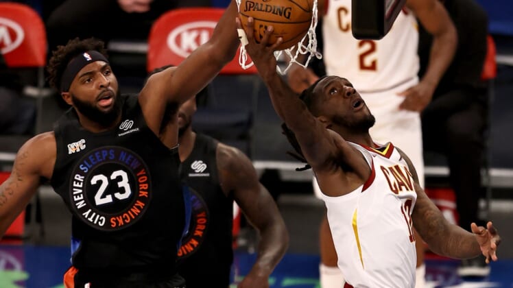 Jan 29, 2021; New York, New York, USA; Cleveland Cavaliers forward Taurean Prince (12) drives to the net against New York Knicks center Mitchell Robinson (23) during the first quarter at Madison Square Garden. Mandatory Credit:  Elsa/Pool Photos-USA TODAY Sports