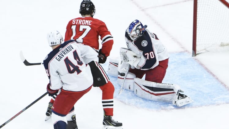 Jan 29, 2021; Chicago, Illinois, USA; Columbus Blue Jackets goaltender Joonas Korpisalo (70) makes a save on Chicago Blackhawks center Dylan Strome (17) during the second period at United Center. Mandatory Credit: David Banks-USA TODAY Sports