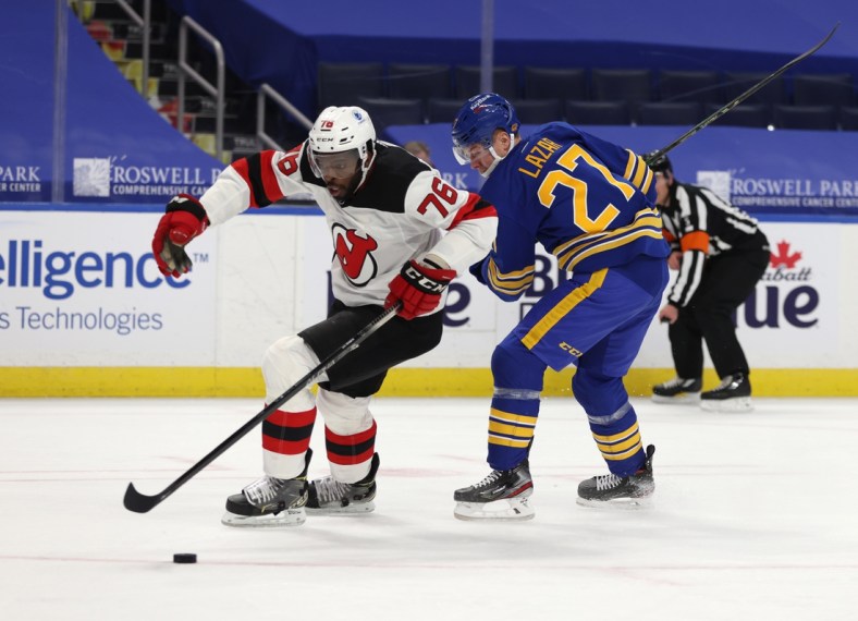 Jan 30, 2021; Buffalo, New York, USA;  New Jersey Devils defenseman P.K. Subban (76) skates with the puck as Buffalo Sabres center Curtis Lazar (27) tries to defend during the second period at KeyBank Center. Mandatory Credit: Timothy T. Ludwig-USA TODAY Sports
