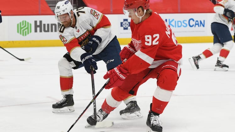 Jan 30, 2021; Detroit, Michigan, USA; Florida Panthers right wing Patric Hornqvist (70) clears the puck as Detroit Red Wings center Vladislav Namestnikov (92) defends during the second period at Little Caesars Arena. Mandatory Credit: Tim Fuller-USA TODAY Sports