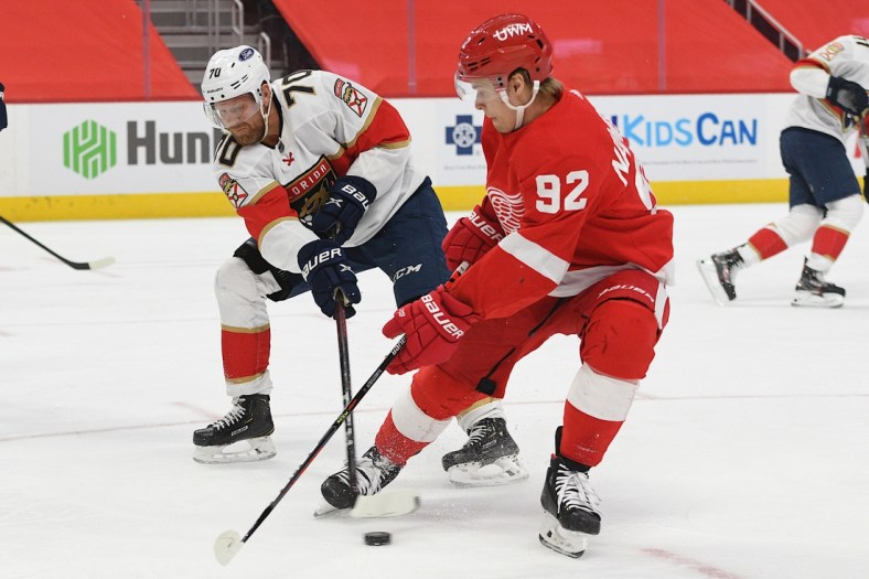 Jan 30, 2021; Detroit, Michigan, USA; Florida Panthers right wing Patric Hornqvist (70) clears the puck as Detroit Red Wings center Vladislav Namestnikov (92) defends during the second period at Little Caesars Arena. Mandatory Credit: Tim Fuller-USA TODAY Sports