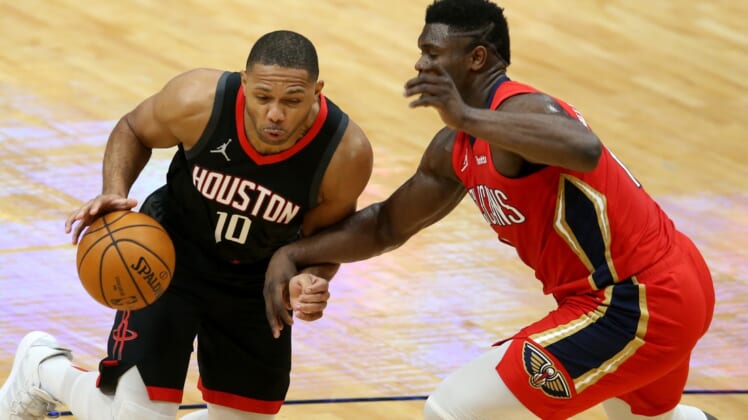 Jan 30, 2021; New Orleans, Louisiana, USA; Houston Rockets guard Eric Gordon (10) drives past New Orleans Pelicans forward Zion Williamson (1) in the second quarter at the Smoothie King Center. Mandatory Credit: Chuck Cook-USA TODAY Sports