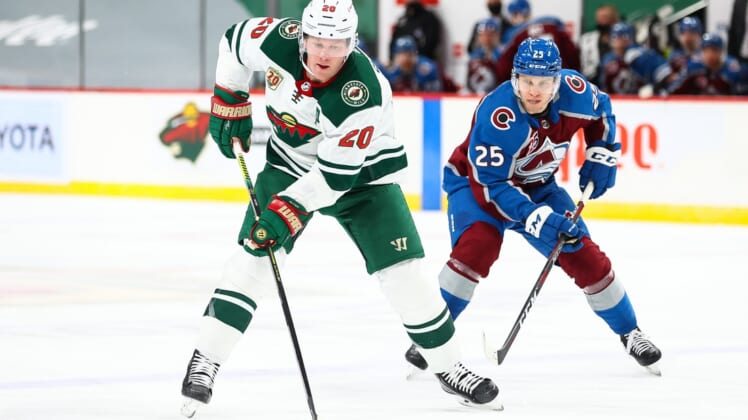 Jan 30, 2021; Saint Paul, Minnesota, USA; Minnesota Wild defenseman Ryan Suter (20) and Colorado Avalanche right wing Logan O'Connor (25) fight for the puck during the second period at Xcel Energy Center. Mandatory Credit: Harrison Barden-USA TODAY Sports