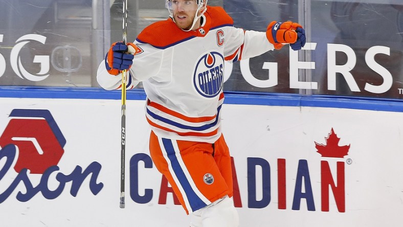 Jan 30, 2021; Edmonton, Alberta, CAN; Edmonton Oilers forward Connor McDavid (97) celebrates his overtime winning goal against the Toronto Maple Leafs at Rogers Place. Mandatory Credit: Perry Nelson-USA TODAY Sports