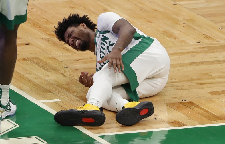 Jan 30, 2021; Boston, Massachusetts, USA; Boston Celtics guard Marcus Smart (36) grabs for his left leg after being injured during the fourth quarter against the Los Angeles Lakers at TD Garden. Mandatory Credit: Winslow Townson-USA TODAY Sports