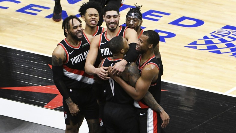 Jan 30, 2021; Chicago, Illinois, USA; Portland Trail Blazers guard Damian Lillard (0) celebrates with his teammates after making the game winning three point basket at the buzzer against the Chicago Bulls during the second half at United Center. Mandatory Credit: David Banks-USA TODAY Sports