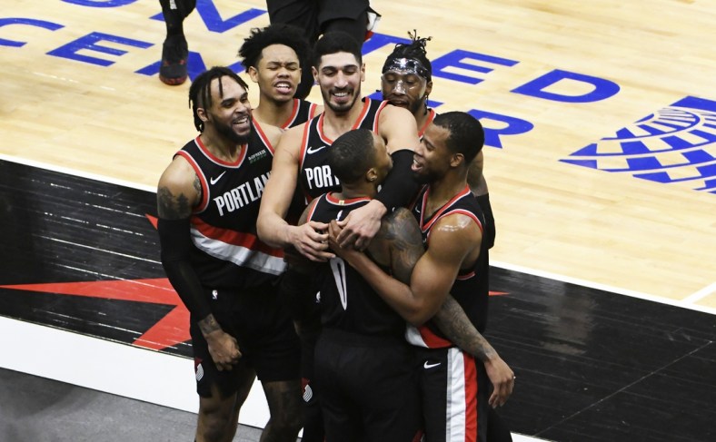 Jan 30, 2021; Chicago, Illinois, USA; Portland Trail Blazers guard Damian Lillard (0) celebrates with his teammates after making the game winning three point basket at the buzzer against the Chicago Bulls during the second half at United Center. Mandatory Credit: David Banks-USA TODAY Sports