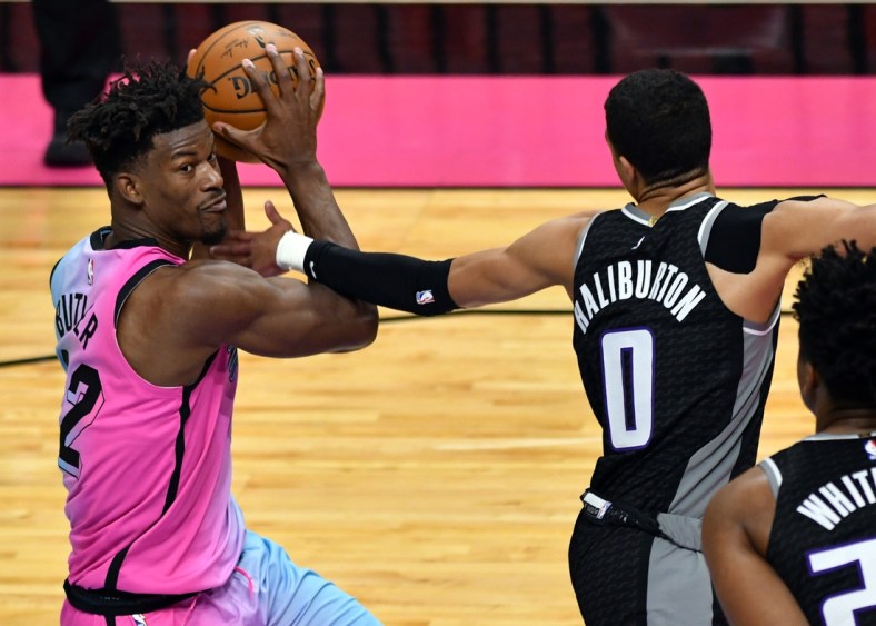 Jan 30, 2021; Miami, Florida, USA; Miami Heat forward Jimmy Butler (22) looks to pass as Sacramento Kings guard Tyrese Haliburton (0) defends on the play in the fourth quarter at American Airlines Arena. Mandatory Credit: Jim Rassol-USA TODAY Sports