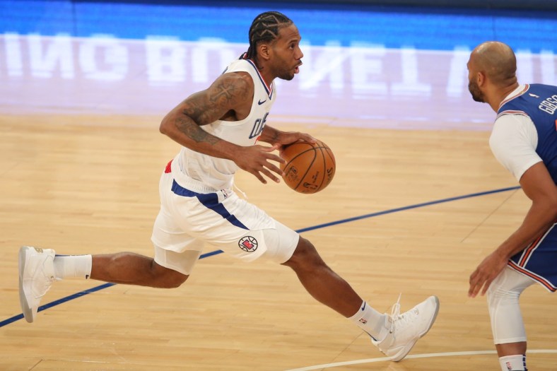 Jan 31, 2021; New York, New York, USA; LA Clippers small forward Kawhi Leonard (2) controls the ball against New York Knicks center Taj Gibson (67) during the first quarter at Madison Square Garden. Mandatory Credit: Brad Penner-USA TODAY Sports